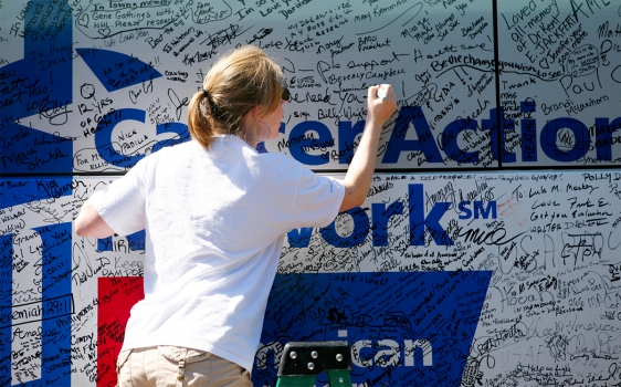 Photo of Fight Back Express bus event participant signing the bus