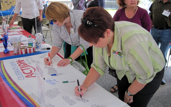 Photo of volunteers signing a petition at an advocacy event