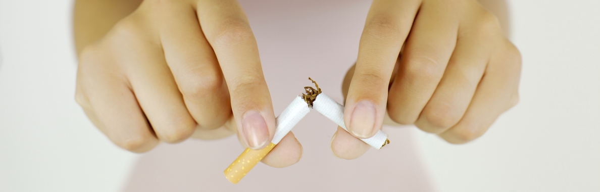 Photo of two hands breaking a cigarette
